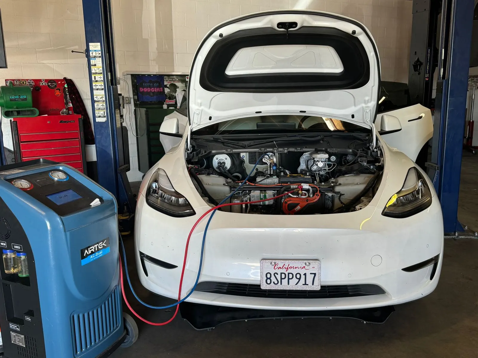 Tesla Model Y on the A/C service machine