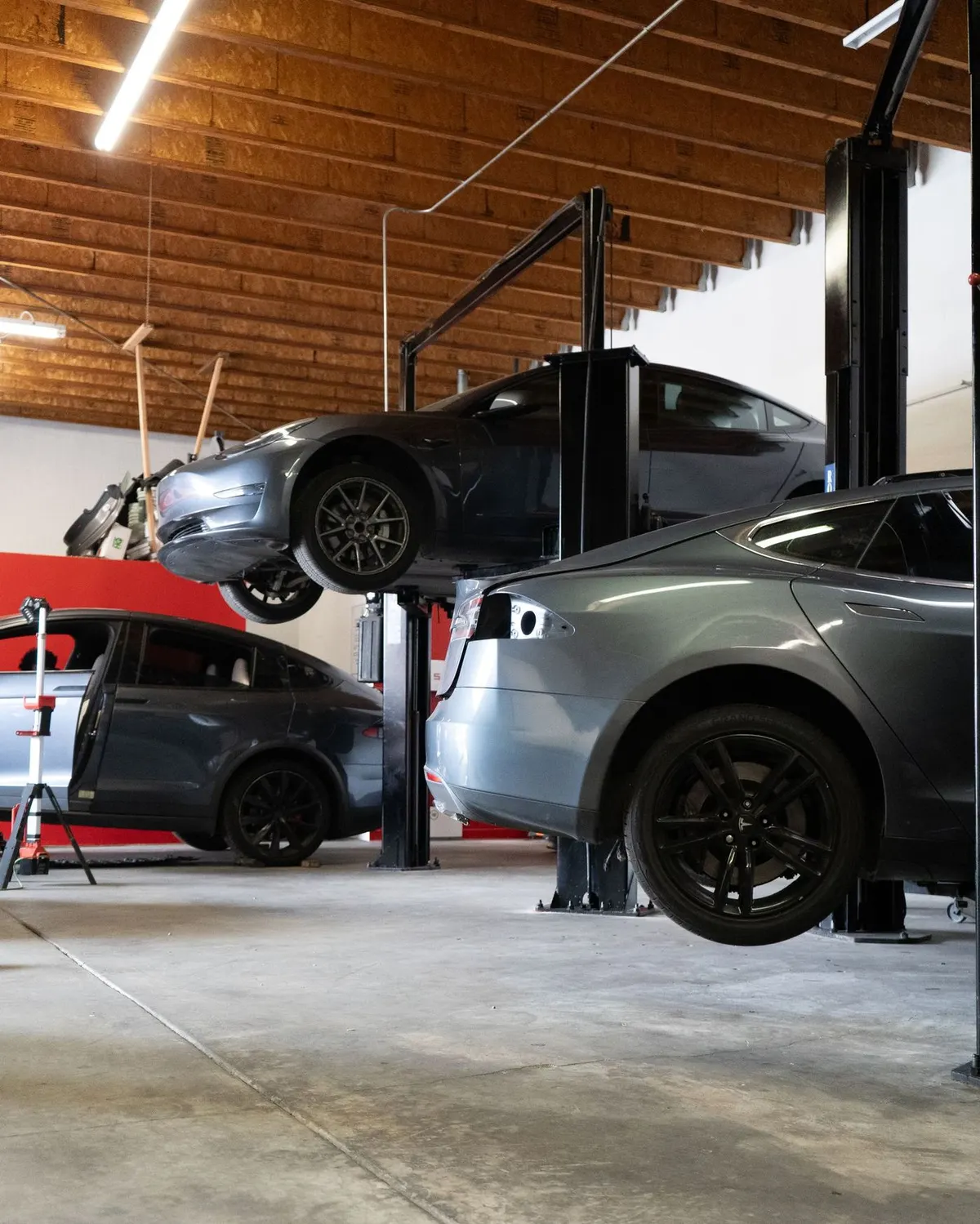 Teslas on lifts inside the Electric City shop
