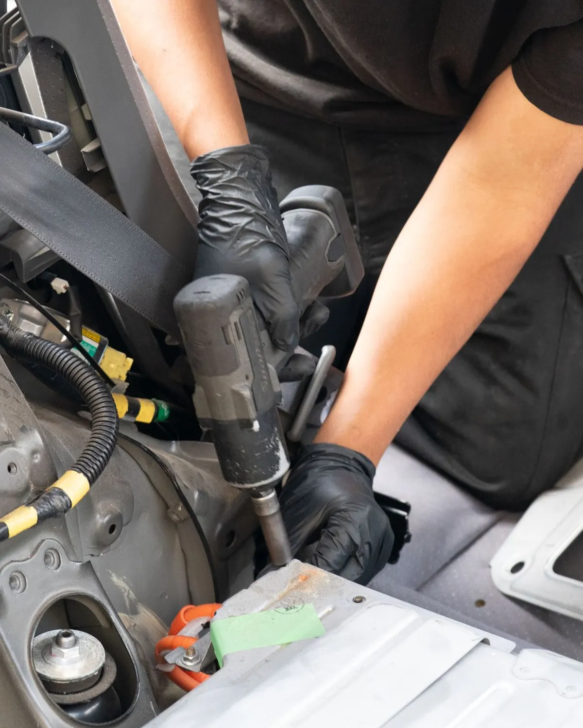 Technician working on a Tesla at Electric City